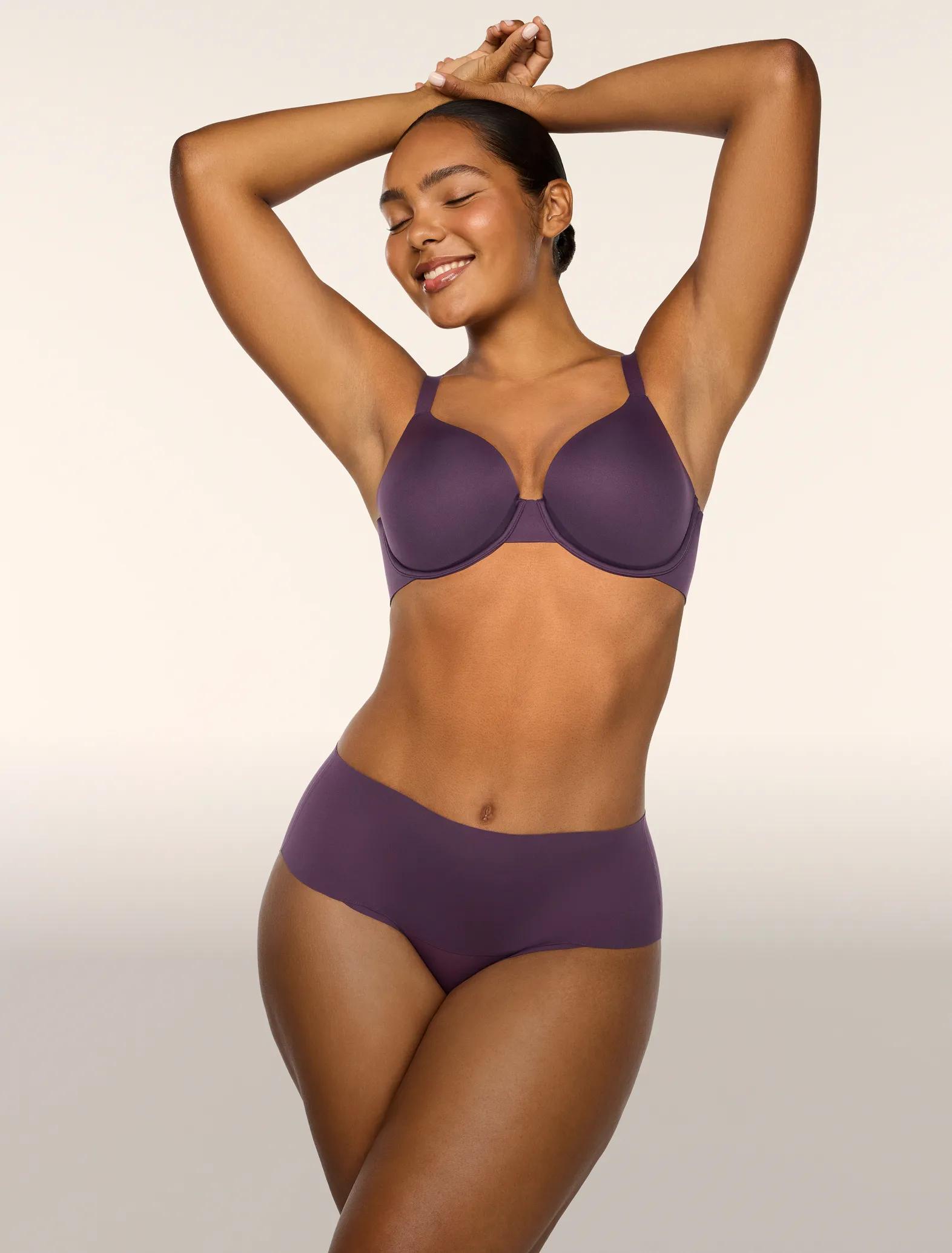 model standing in purple Spanx bra and panty set