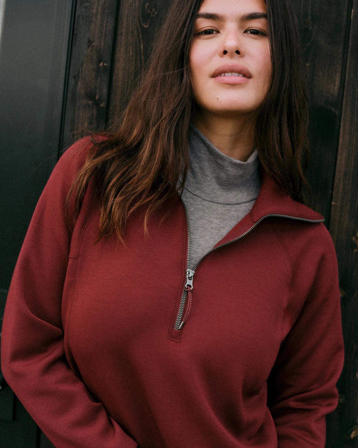 woman in spanx airessentials half zip in rum raisin color