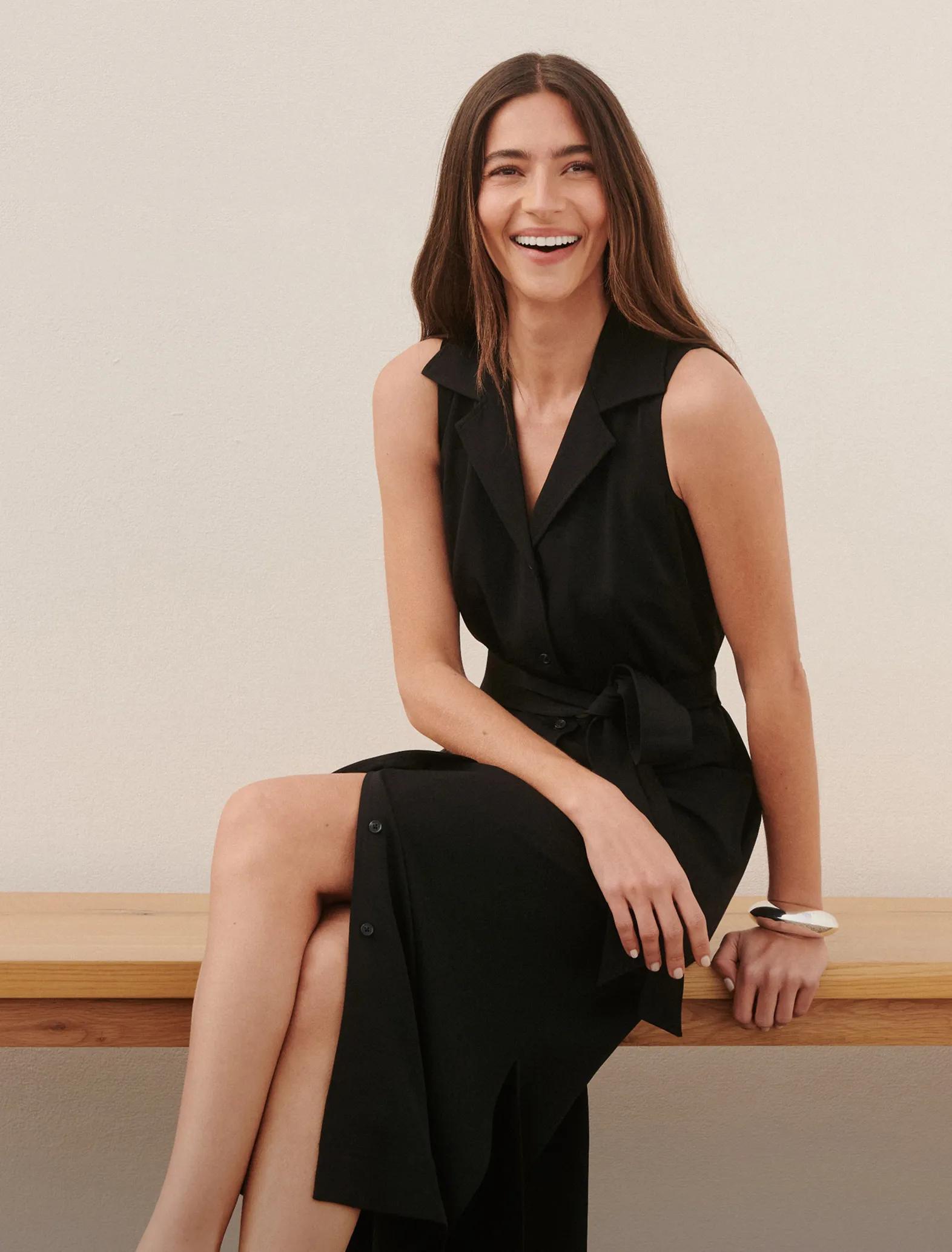 Woman in black SPANX CarryOn Dress