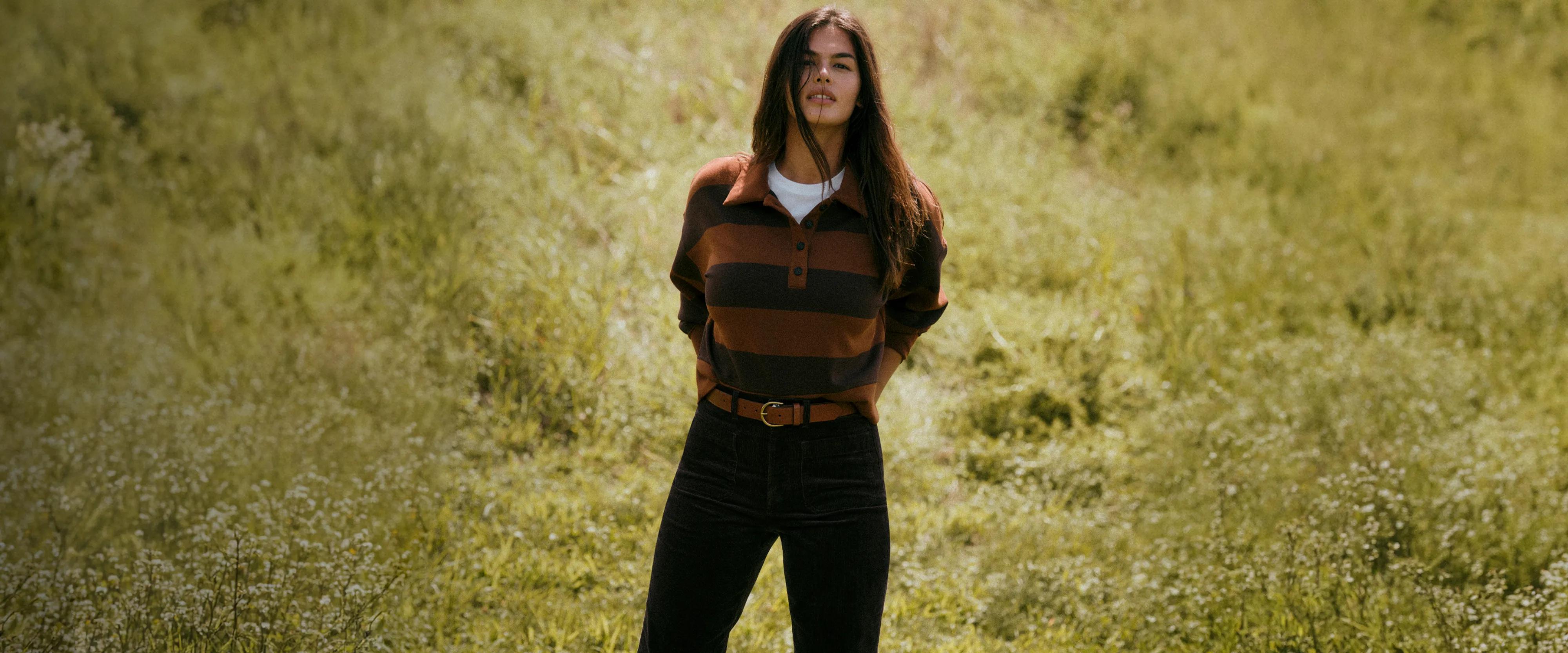 a model in a field in SPANX airessentials rugby top