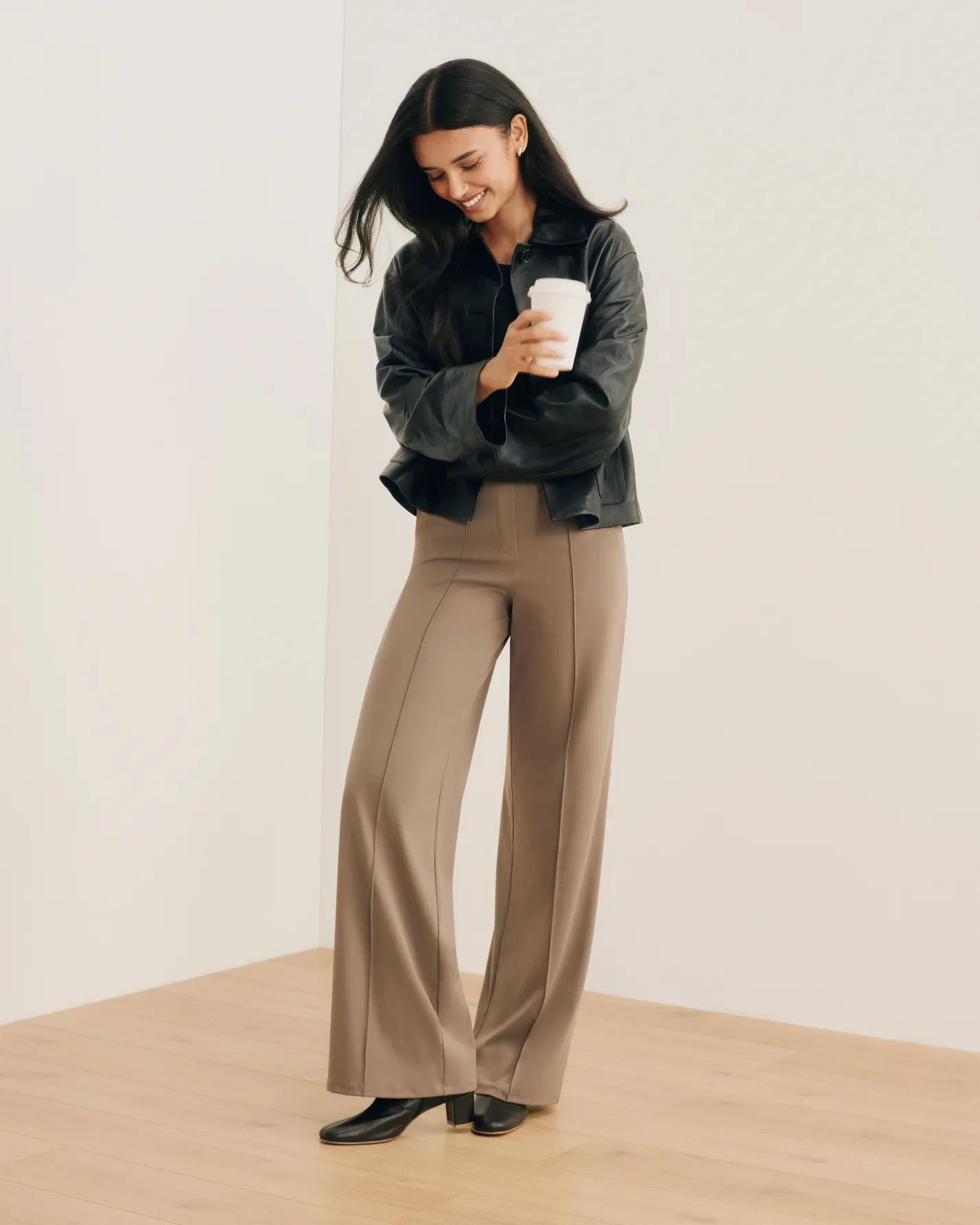 model standing in spanx powermove trousers in tan color